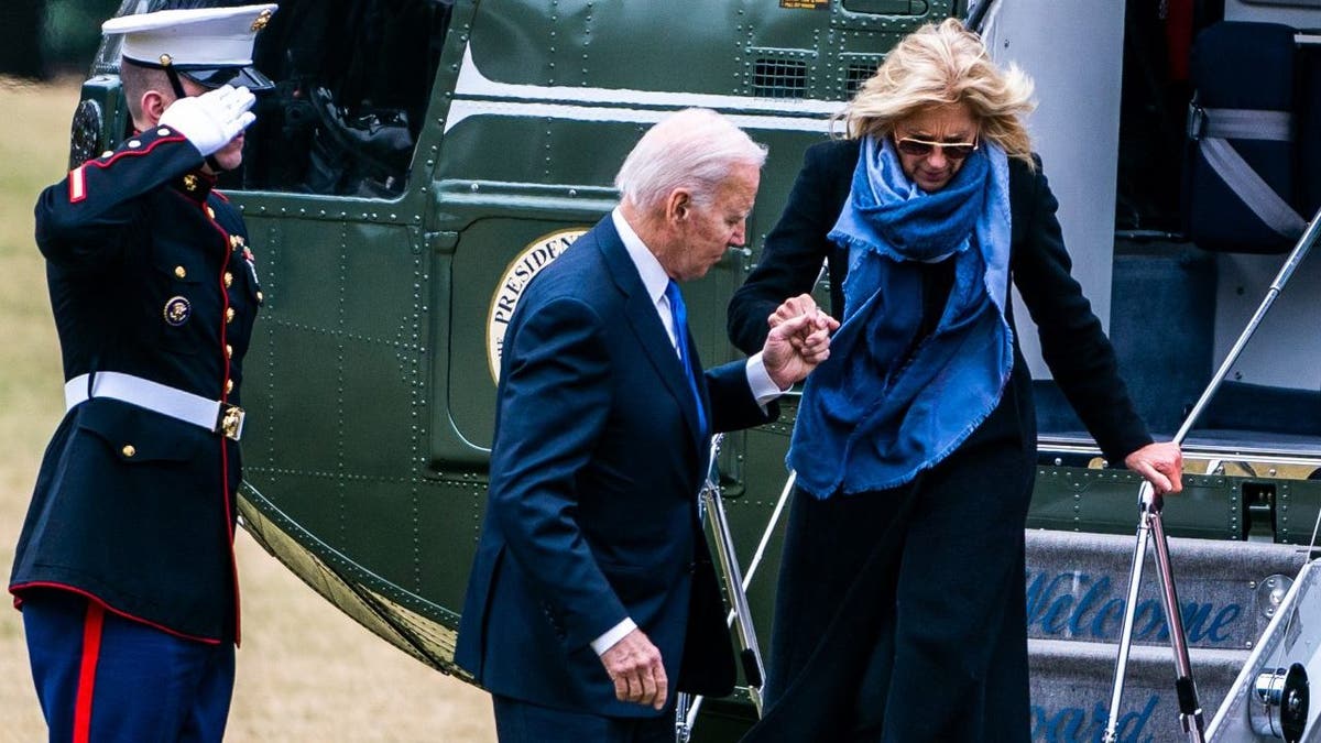 President Joe Biden helps First Lady Dr. Jill Biden