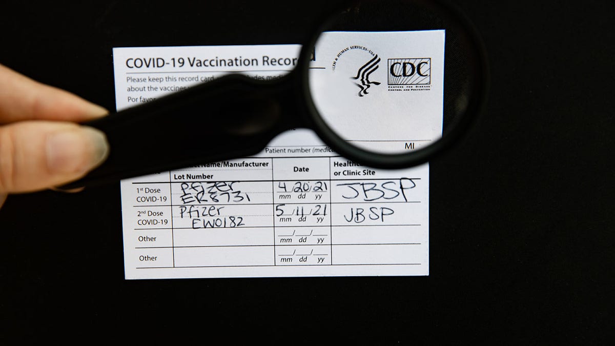 CDC vaccine card magnifying glass