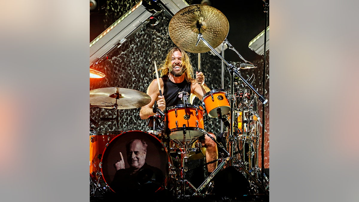 Taylor Hawkins in a black sleeveless shirt plays the drums for the Foo Fighters in Australia