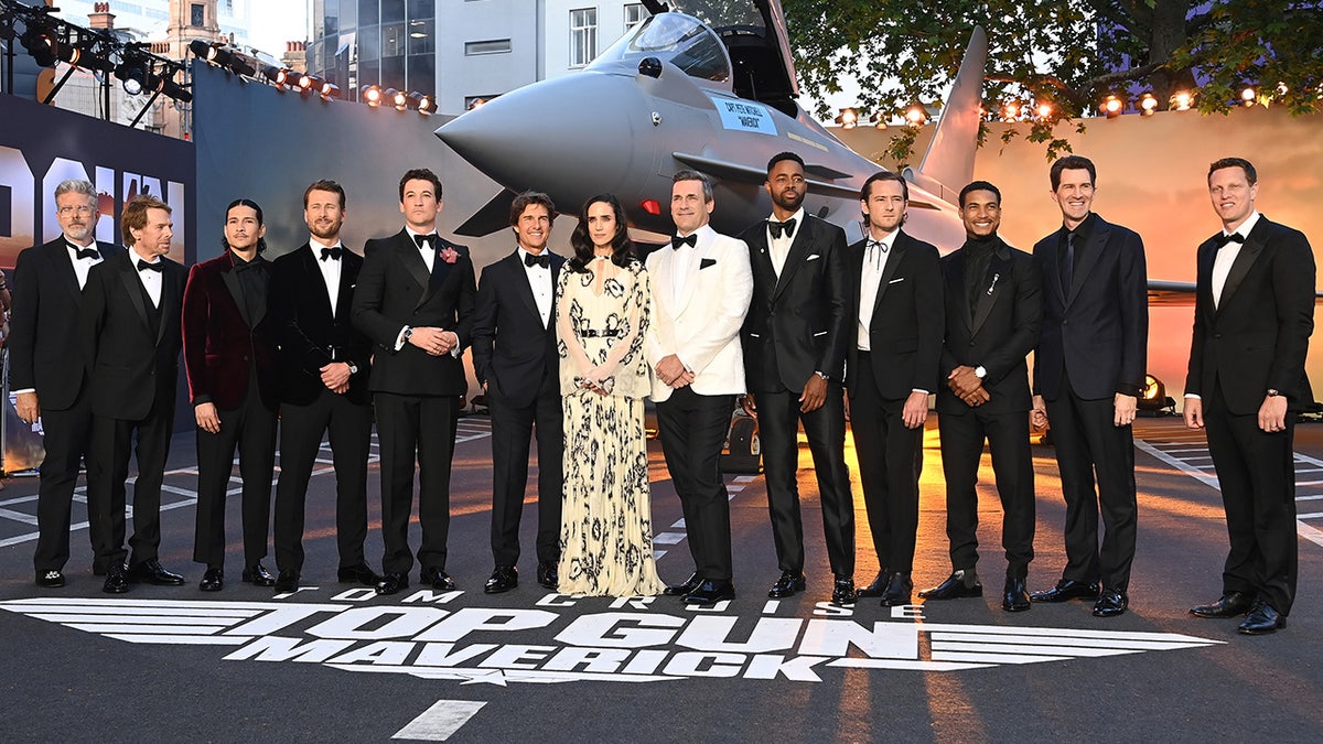 The cast of "Top Gun: Maverick" fronted by Tom Cruise poses for a photo in London at the premiere of "Top Gun: Maverick," Jennifer Connelly is the only woman in the photo