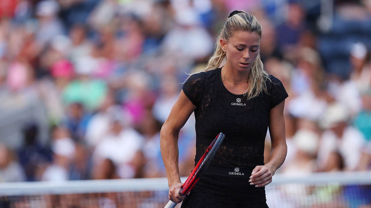 Camila Giorgi reacts after losing a match at the US Open