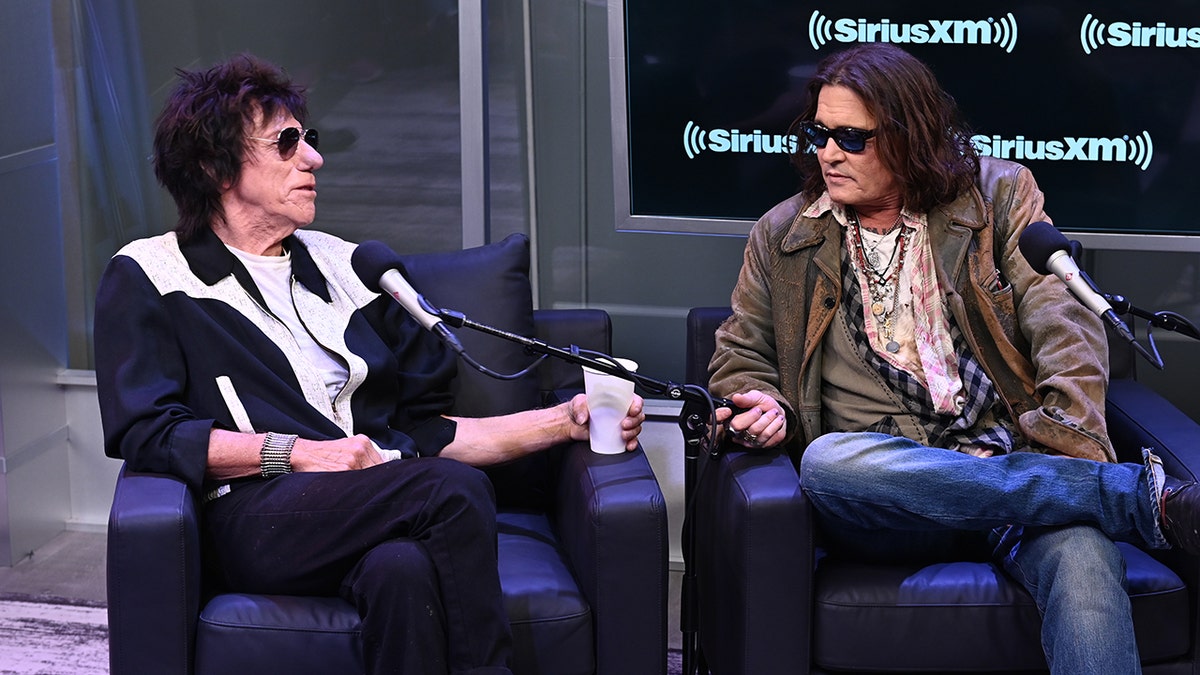 Johnny Depp and Jeff Beck sit for an interview at the SirusXMs Town Hall in New York City and look at each other in conversation