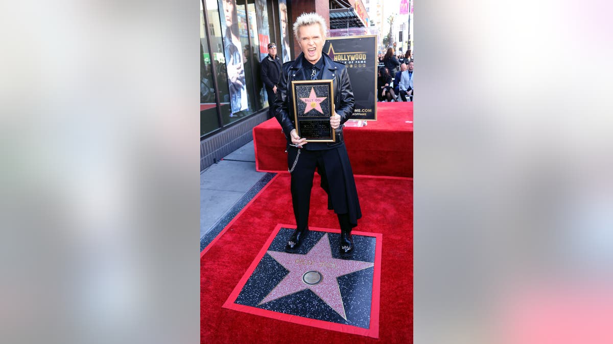 billy idol holding star plaque standing on star