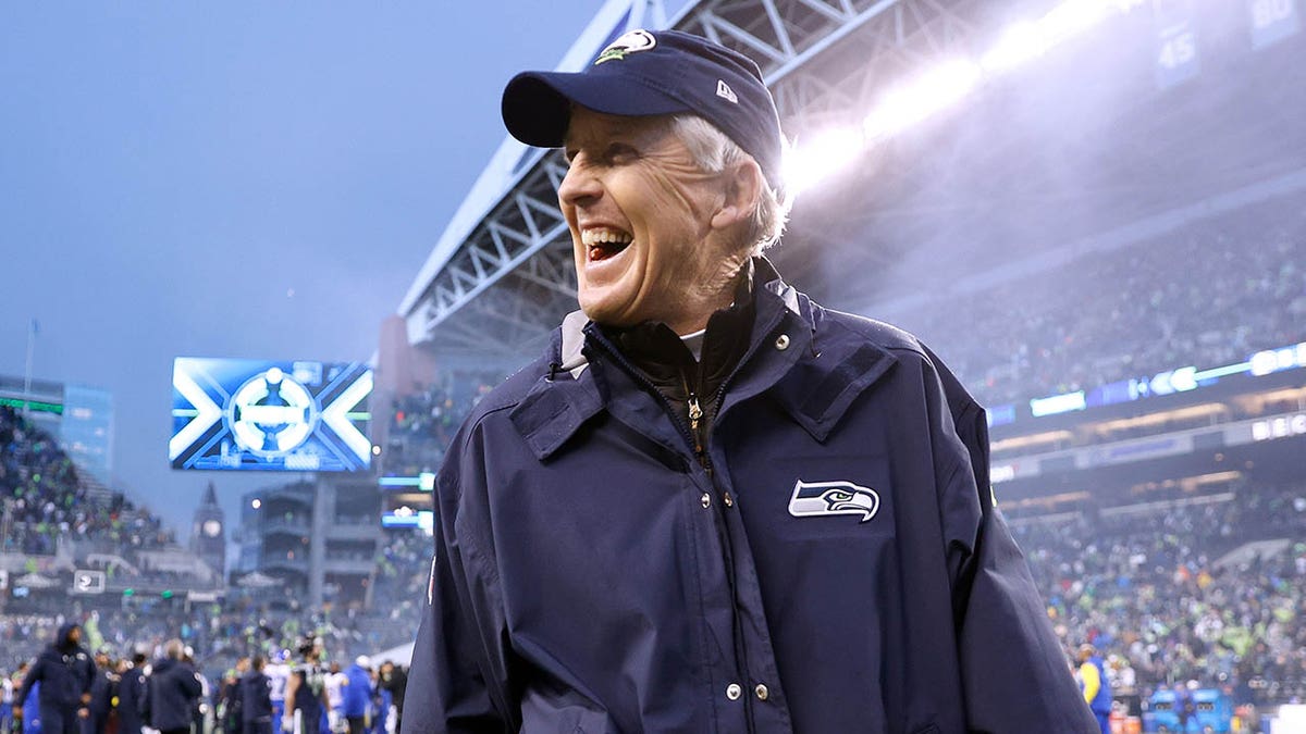 Pete Carroll walks off the field after defeating the Rams