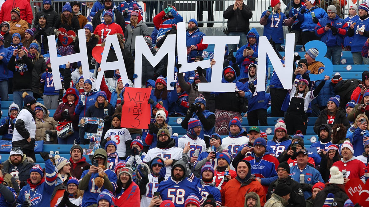 Buffalo Bills fans hold a sign for Damar Hamlin