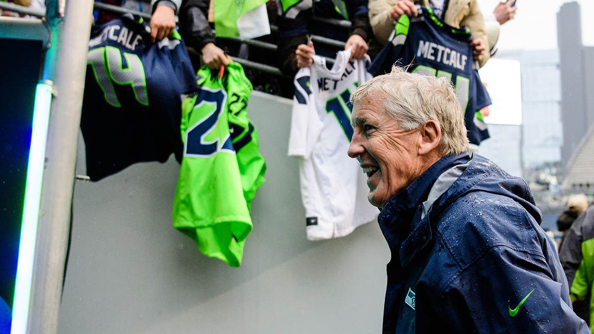 Pete Carroll walks off the field after defeating the Rams