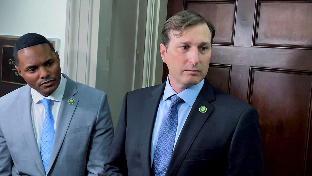 Ritchie Torres and Dan Goldman standing in front of George Santos' office 