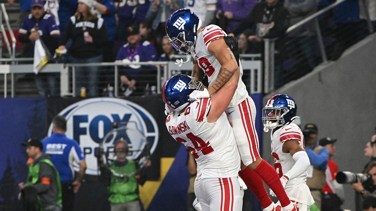 Isaiah Hodgins celebrates a touch down