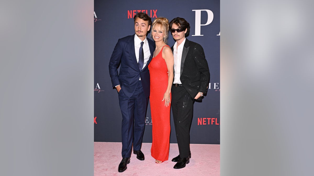 Brandon Thomas Lee, Pamela Anderson, and Dylan Jagger Lee pose together at the premiere of "Pamela, a love story"