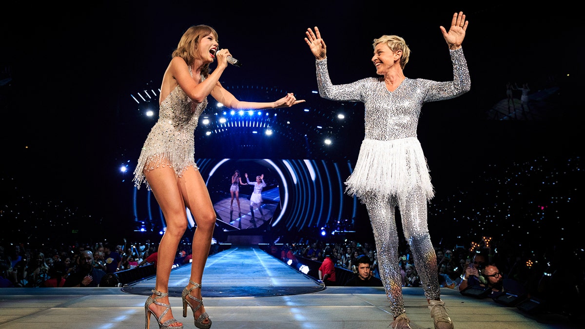 Taylor Swift during her "1989" tour dancing with Ellen DeGeneres, both wearing sparkly outfits