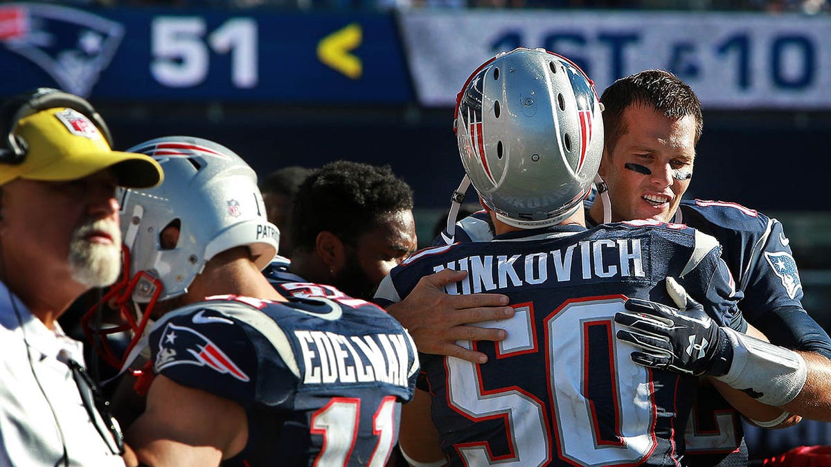 Tom Brady hugs Rob Ninkovich