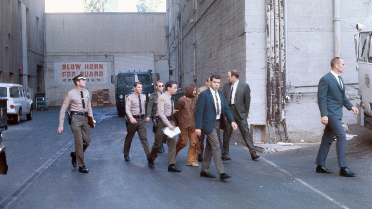 Charles Manson is escorted by police