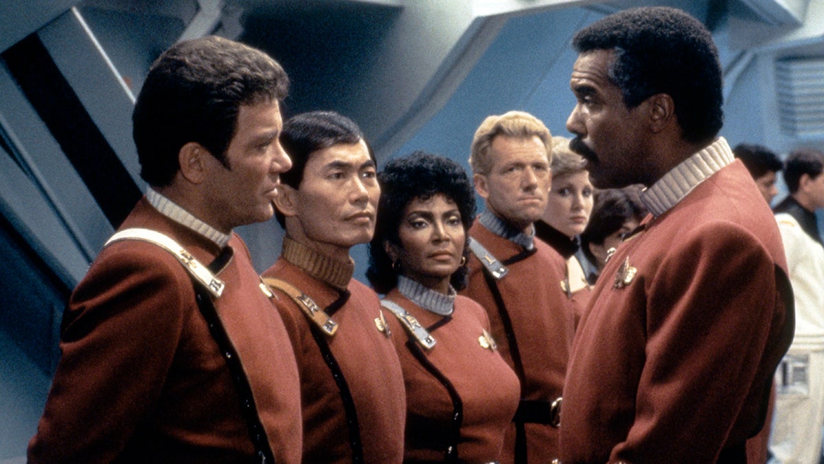 William Shatner, George Takei, Nichelle Nichols and Robert Hooks all on the set in their red uniforms for "Stark Trek III: The Search for Spock"