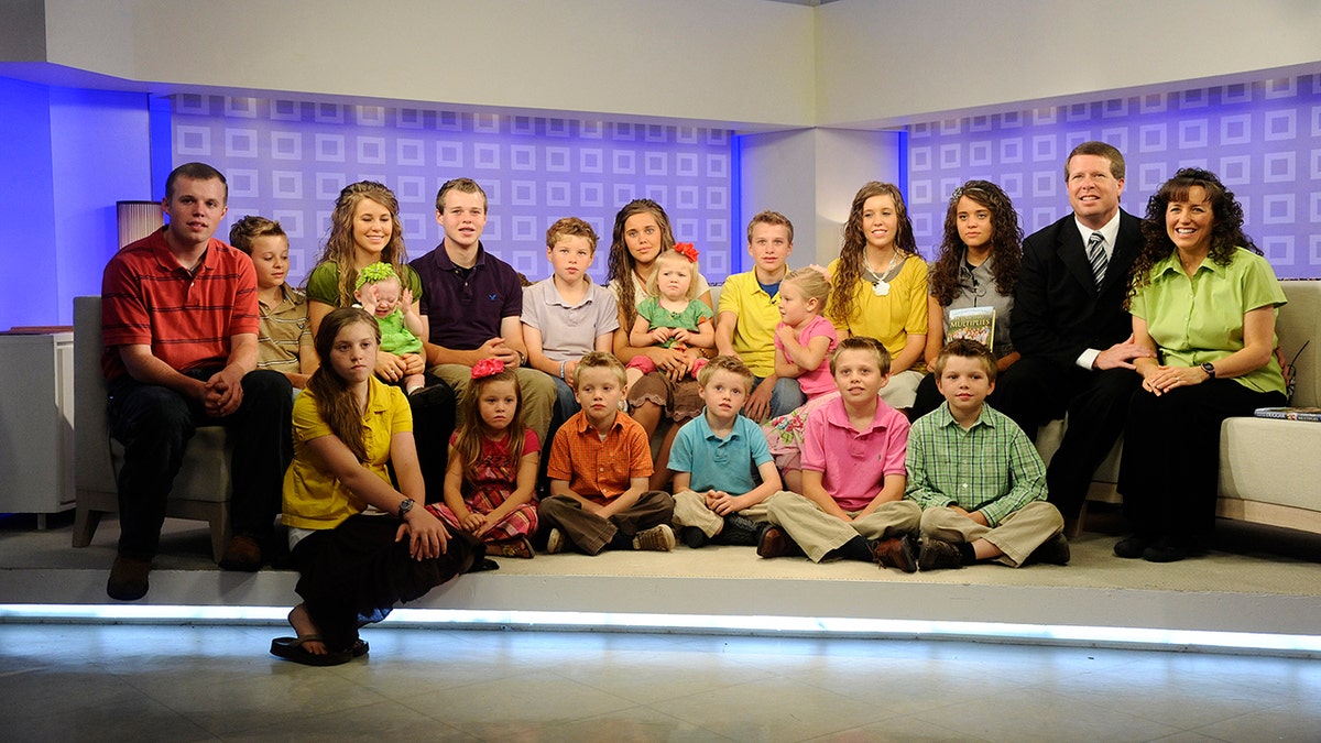 The Duggar Family posing during a media engagement to promote their reality TV series