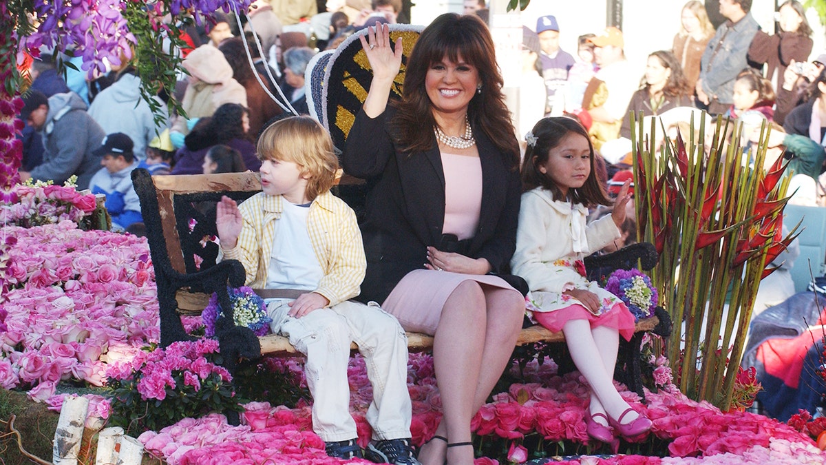 Marie Osmond smiling during a public engagement with children