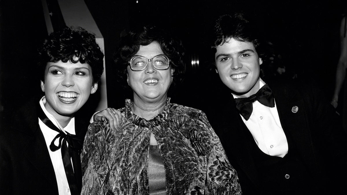Marie Osmond smiling with her mother Olive Osmond and her brother Donny Osmond