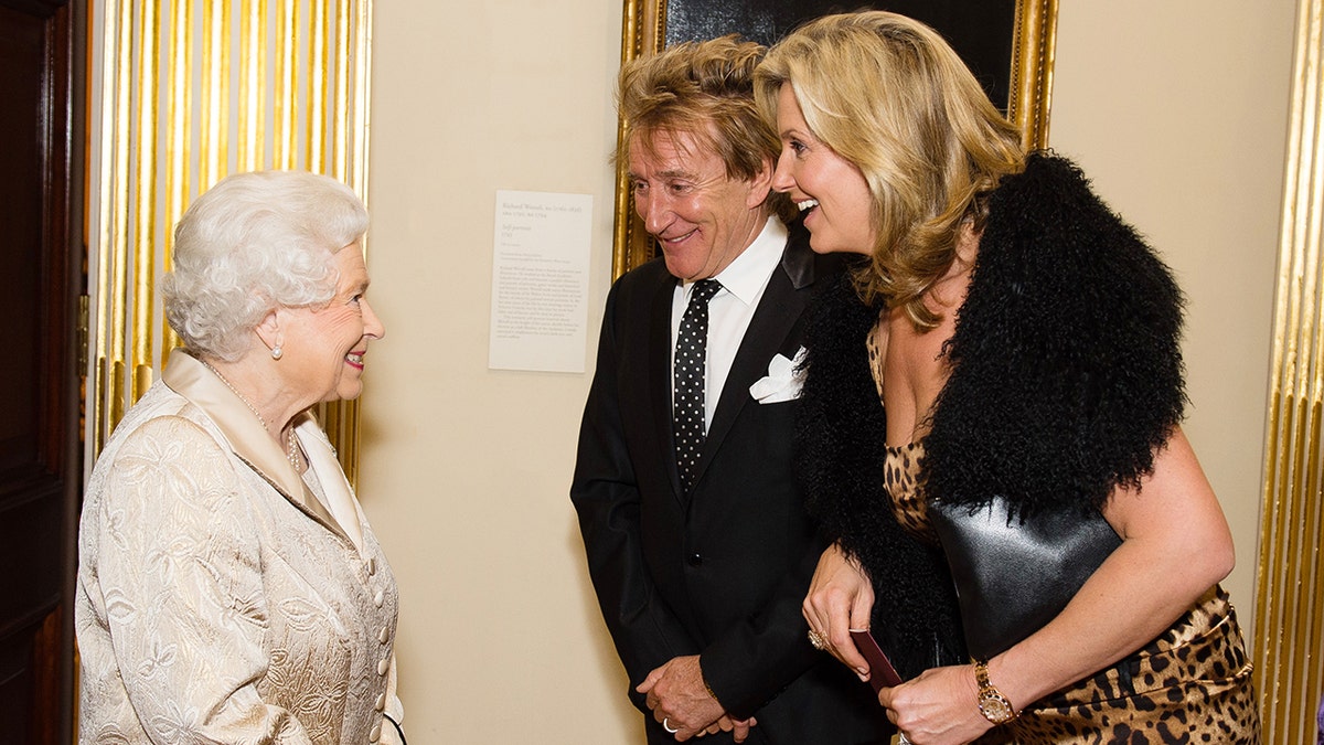 Queen Elizabeth greeting Rod Stewart and his wife