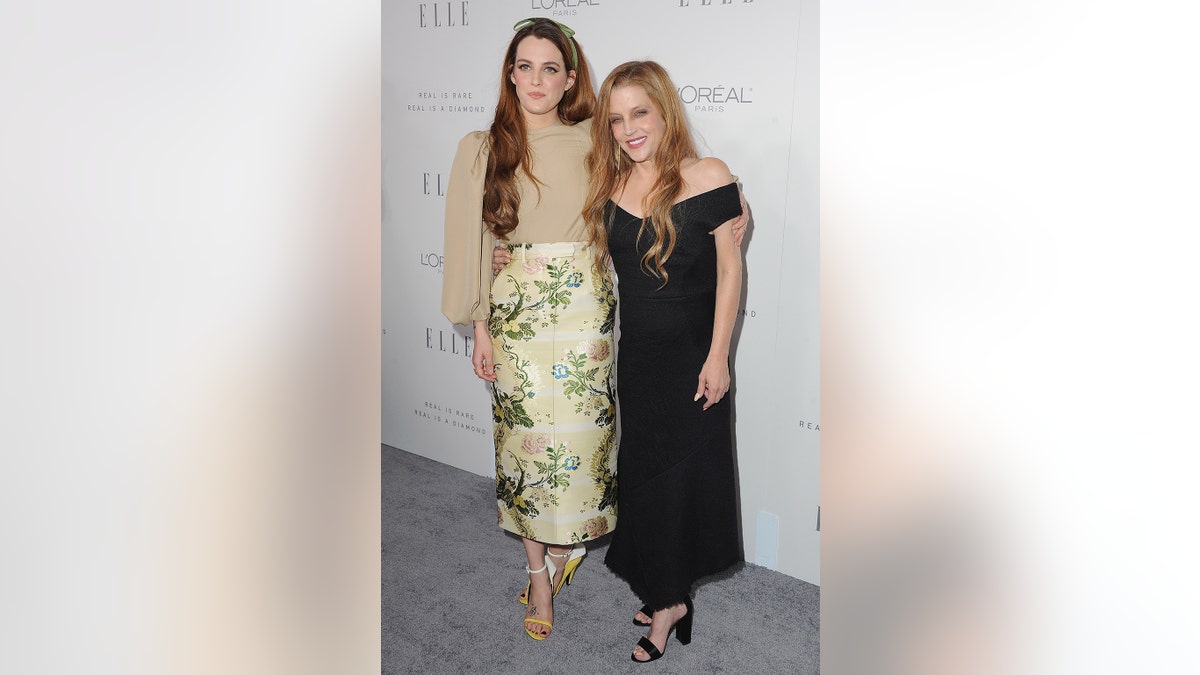 RIley Keough and her mother Lisa Marie Presley on the red carpet smiling