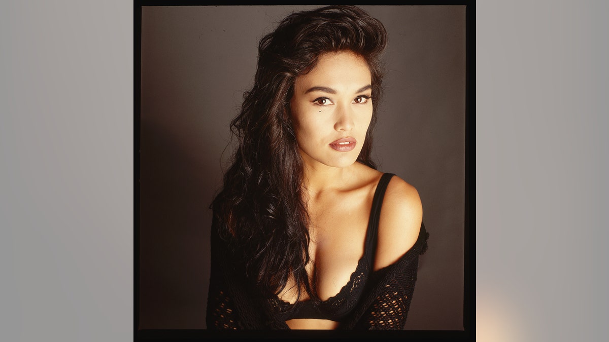 Tia Carrere wearing black in the '90s