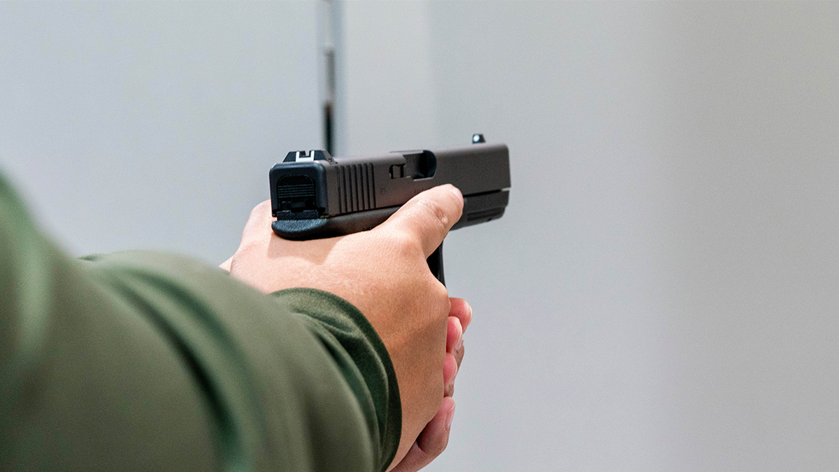 Customer holding a gun at gun store