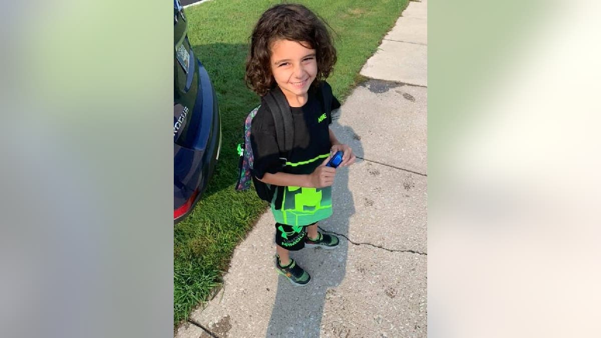 Hunter Tuzinski smiles while wearing backpack