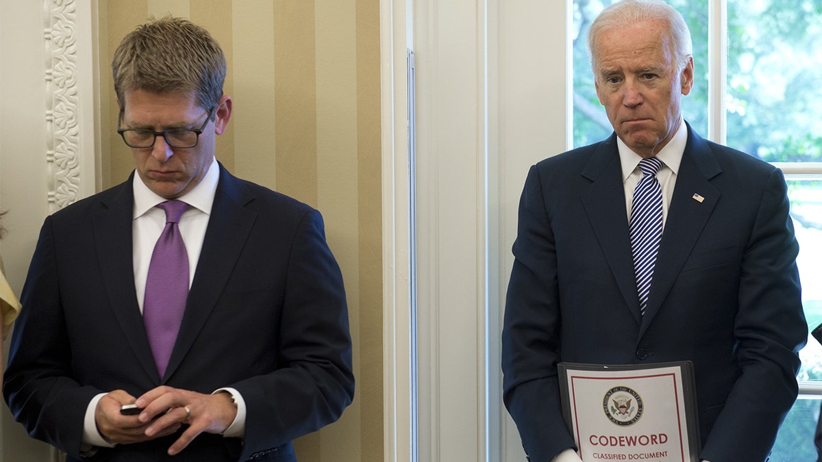Joe Biden holds a classified document as vice president in 2013
