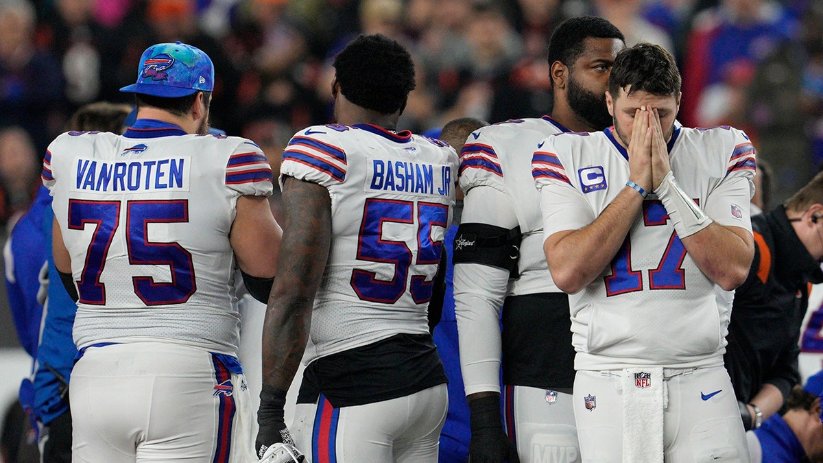 Buffalo Bills quarterback Josh Allen (17) pauses as Damar Hamlin is examined during the first half of an NFL football game against the Cincinnati Bengals, Monday, Jan. 2, 2023, in Cincinnati.