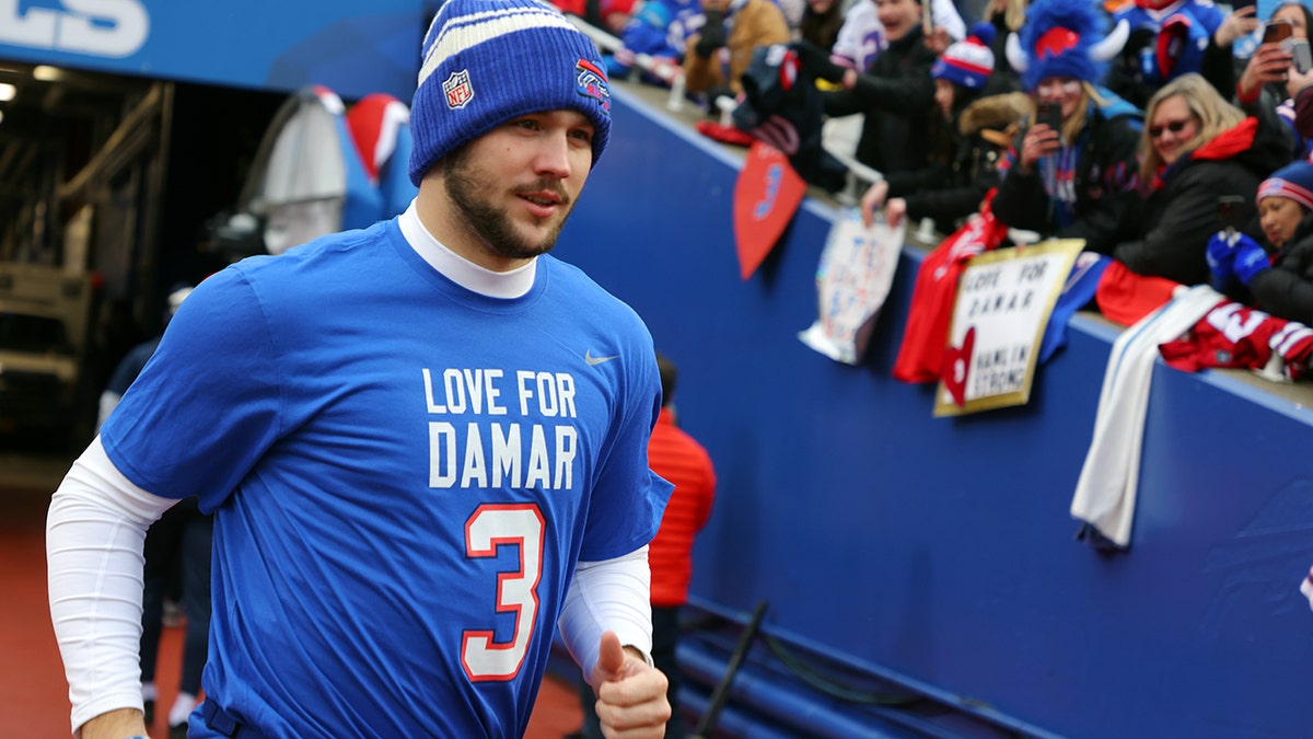 Josh Allen runs onto the field