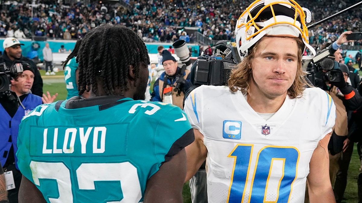 Justin Herbert shakes the hands of Jags players