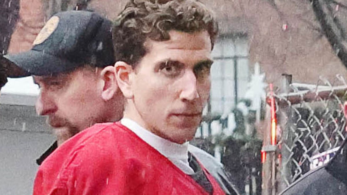 Kohberger wearing a reddish jailhouse rumor jumpsuit