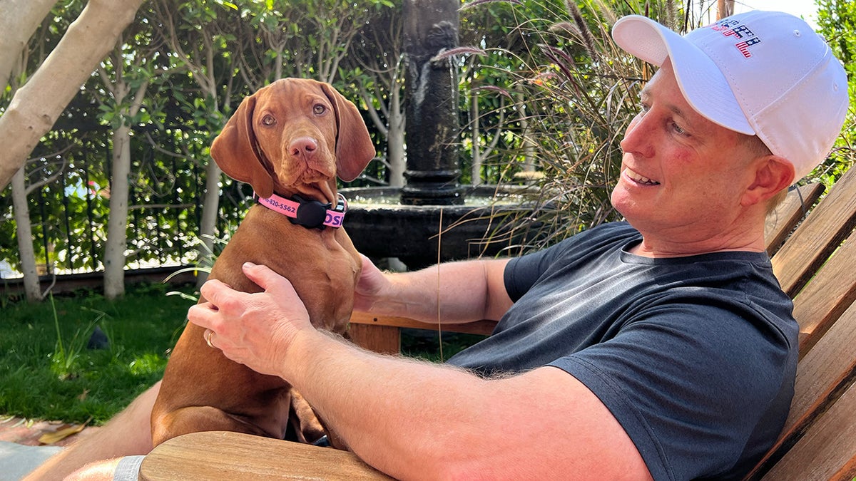 Kurt and Rosie the dog sit out in the sun