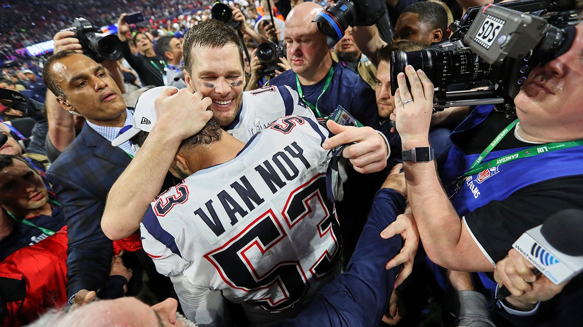 Kyle Van Noy and Tom Brady embrace