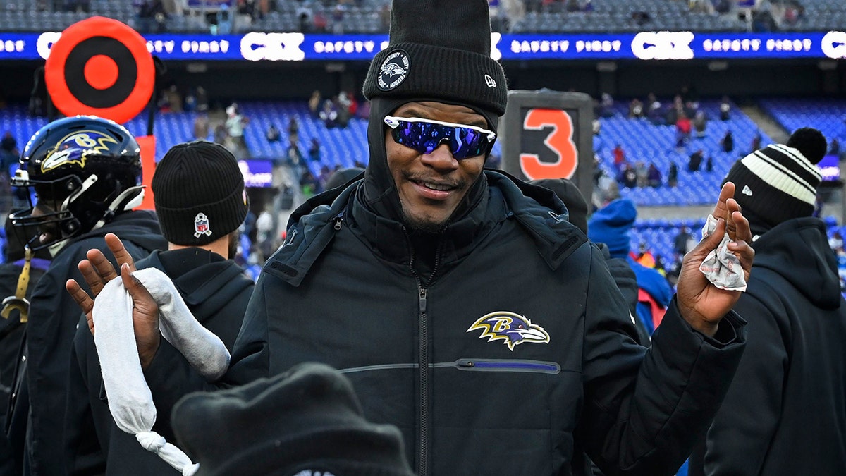 Lamar Jackson smiles with glasses on