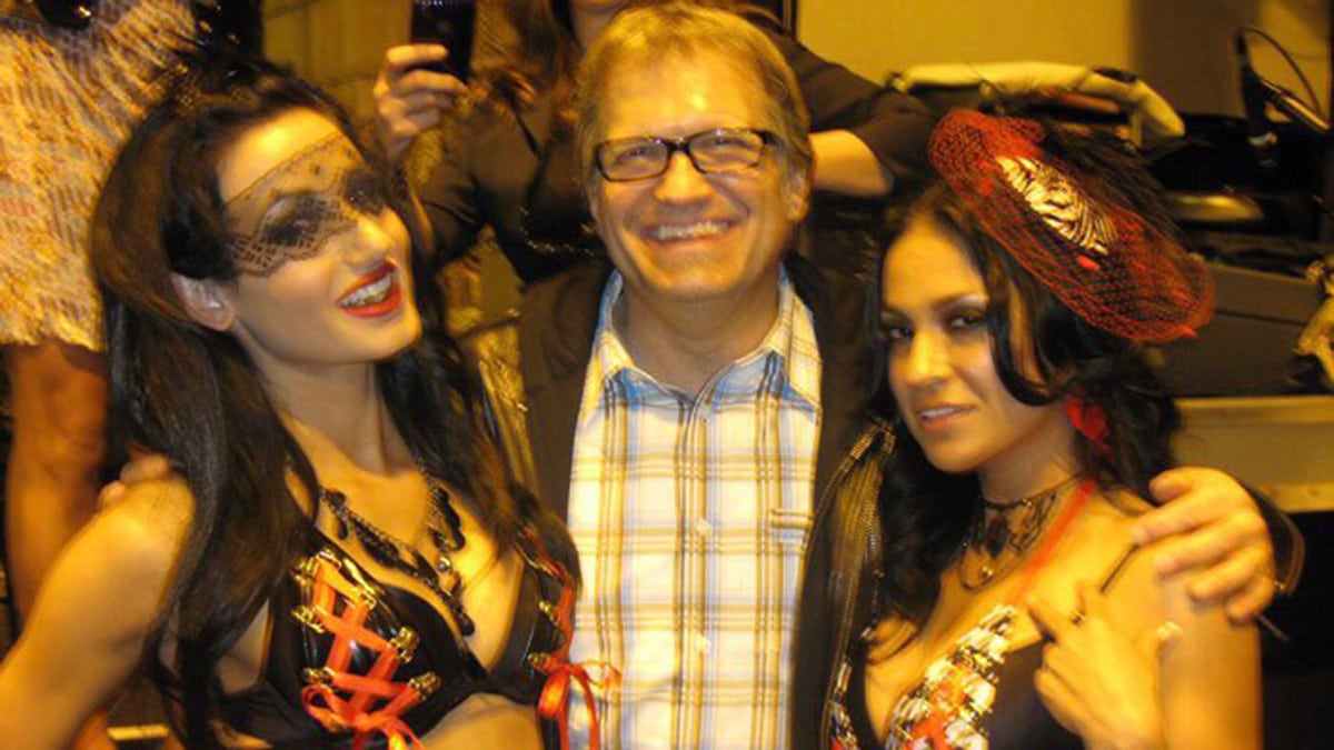 Amie Harwick, Drew Carey and Marcy Mendoza at a party and smiling