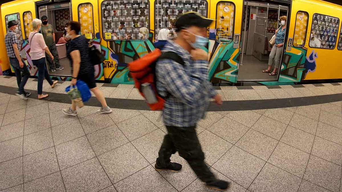 People in masks at subway station