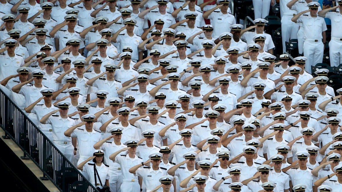 Merchant Marines in uniform saluting