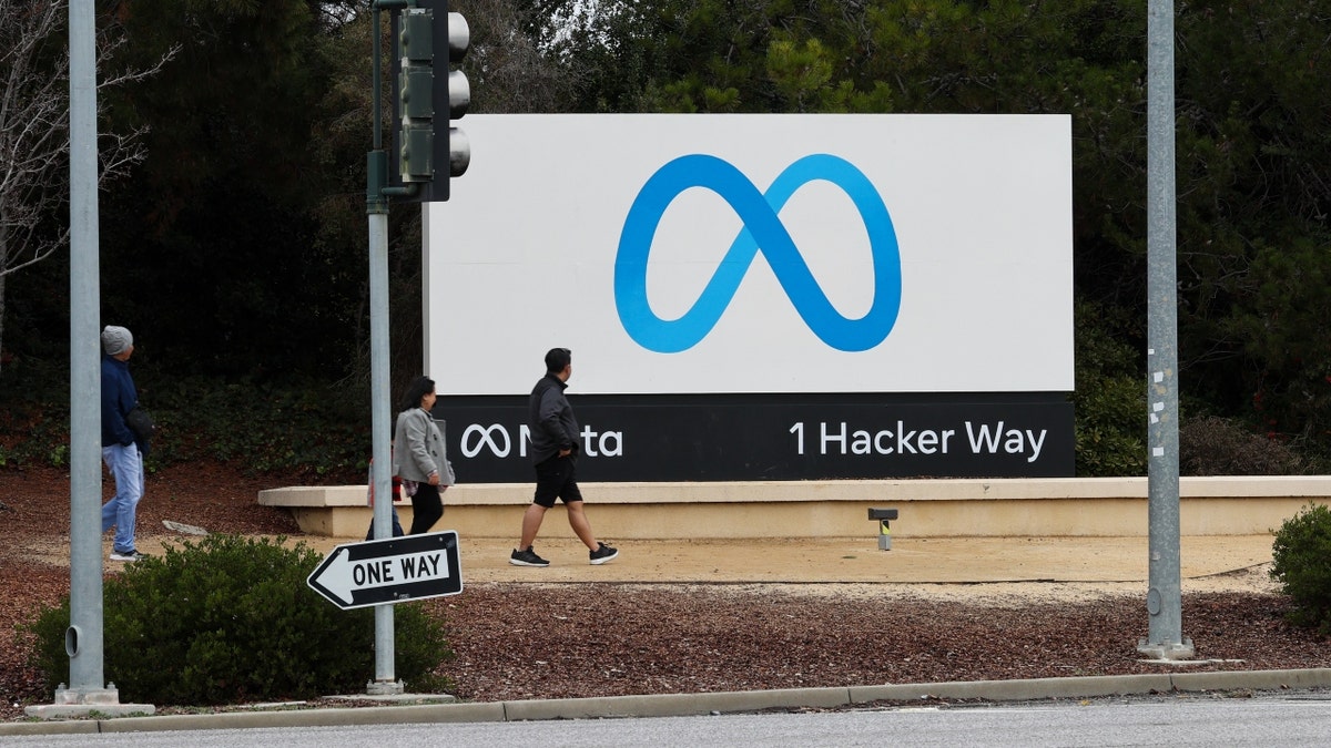 People walk in front of the Meta headquarters