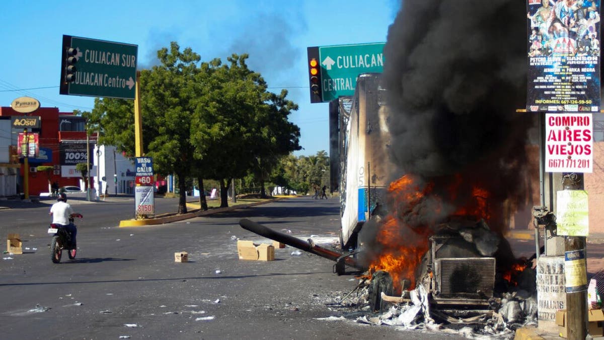 A truck burns after being set on fire on a street in Culiacan, Sinaloa state, Mexico, on Thursday. Mexican security forces captured Ovidio Guzmán, an alleged drug trafficker wanted by the U.S. and one of the sons of former Sinaloa cartel boss Joaquín "El Chapo" Guzmán, in a pre-dawn operation that set off gunfights and roadblocks across the western state’s capital.