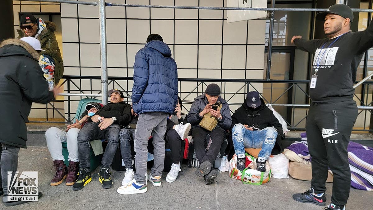 Migrants are seen outside the Watson Hotel in New York City on Jan. 30, 2023.