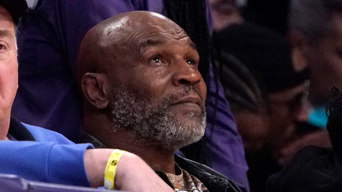 Mike Tyson watches the first half of an NBA game