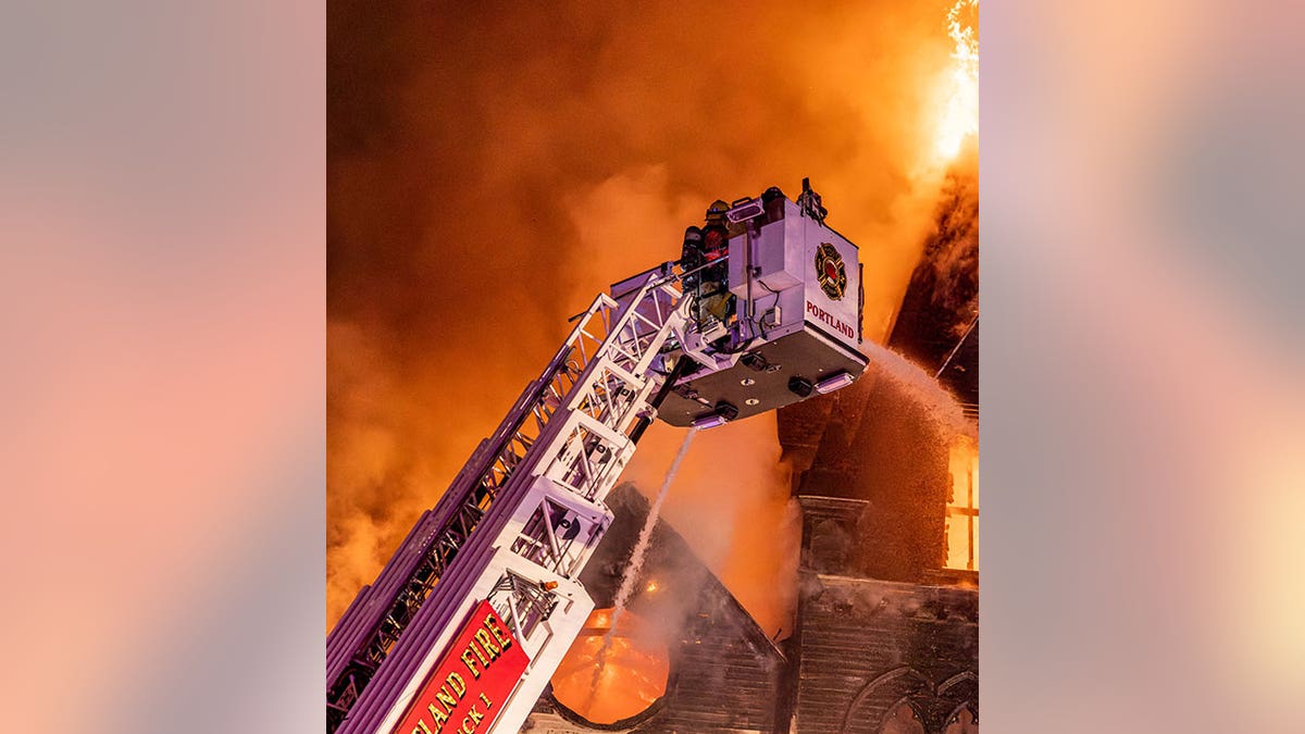 Portland firefighters in crane