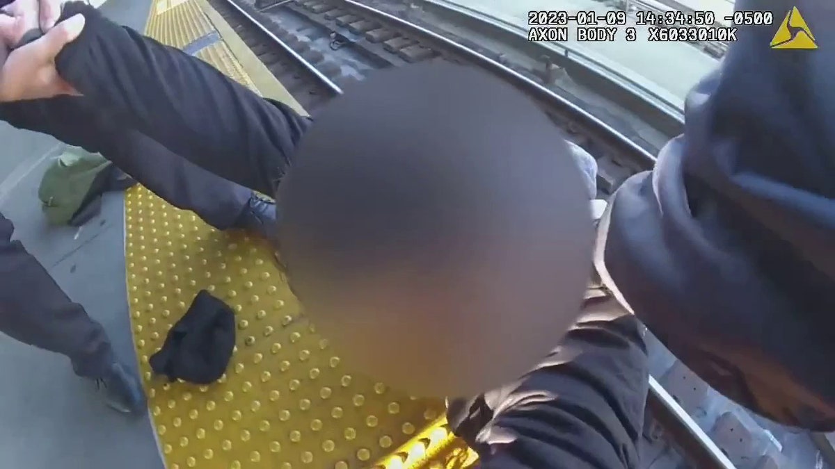 man on subway tracks