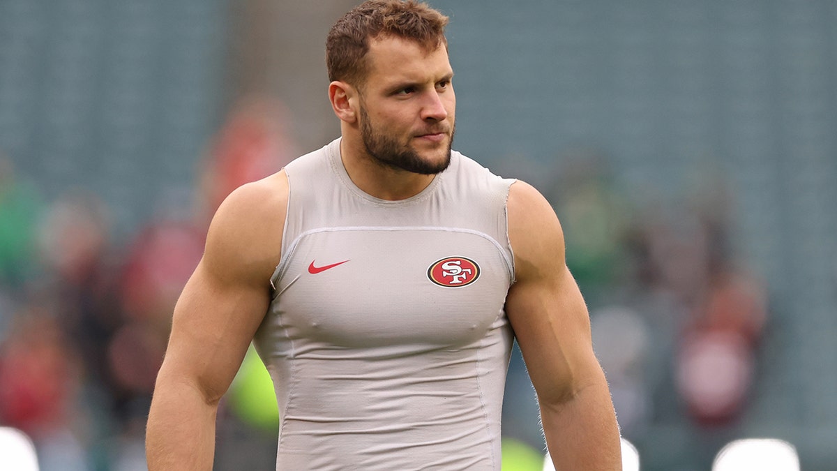 Nick Bosa warms up