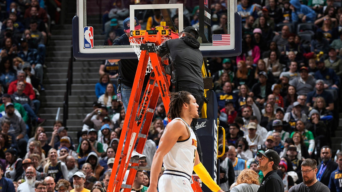 Workers fix the bent rim