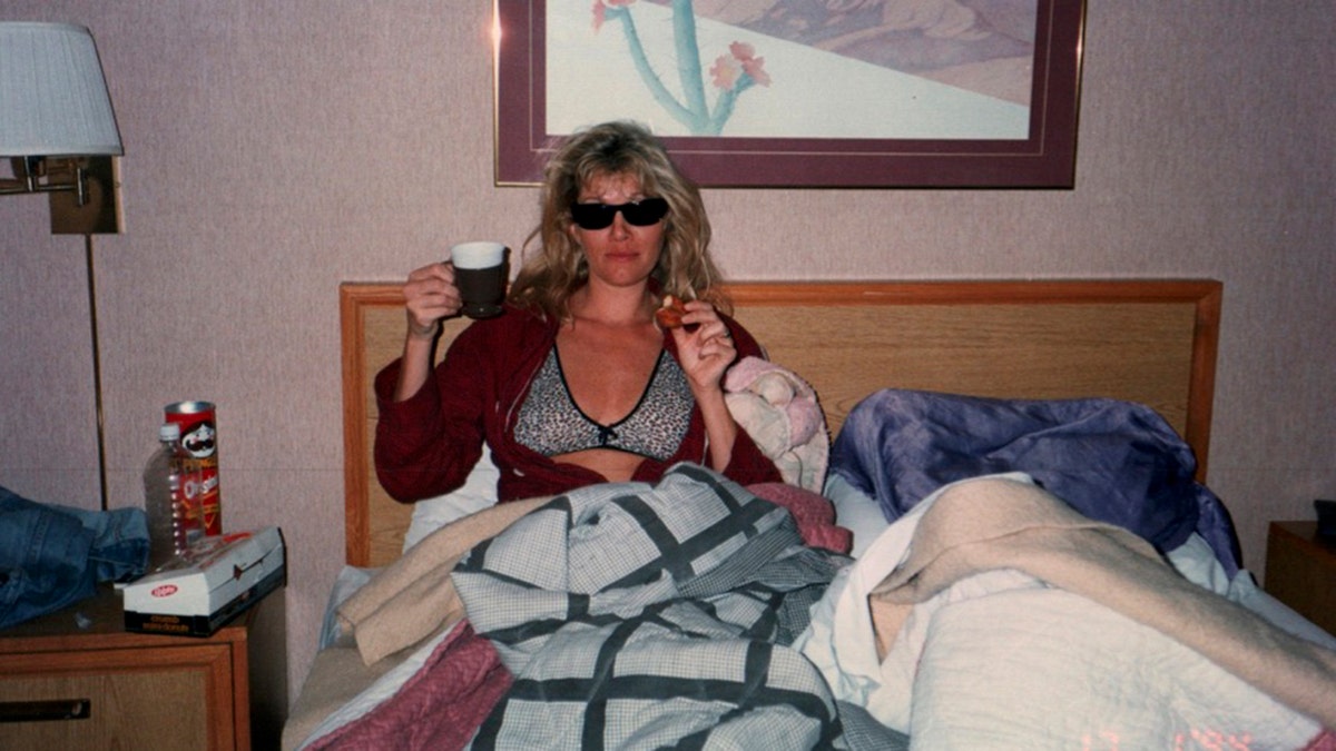 Lana Clarkson in bed wearing sunglasses