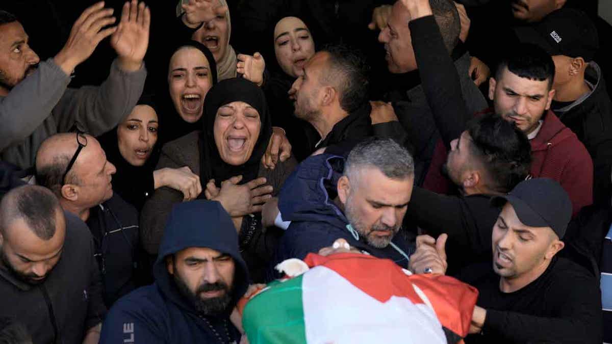 Women mourn for a Palestinian teacher