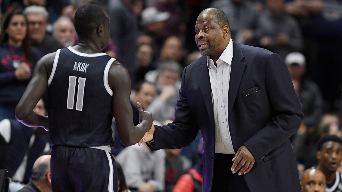 Patrick Ewing greets a player