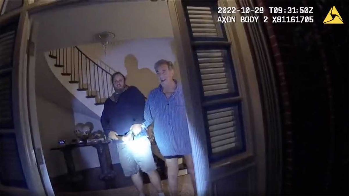 Body cam footage shows two men at the door of a home