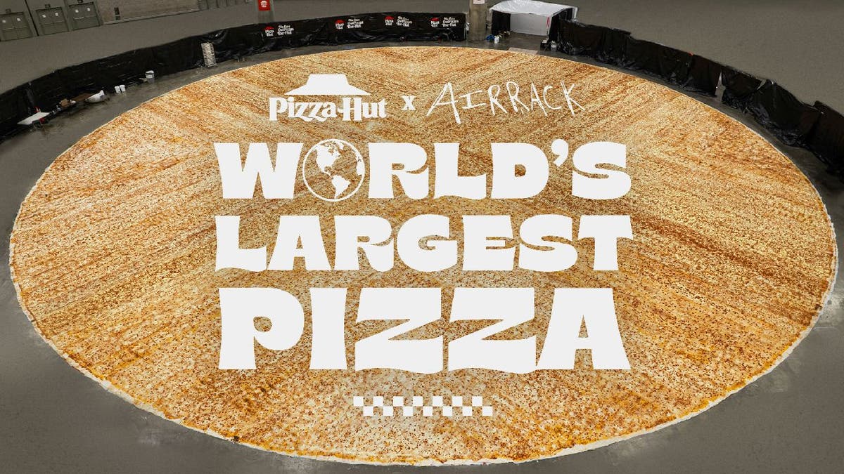 World's largest pizza in Los Angeles Convention Center with Pizza Hut and Airrack logos