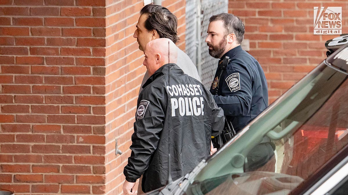 Man is led into court by two police officers